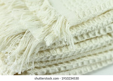 Ivory beige blanket waffle cloth close up, fabric knitwear soft texture, home decoration element, rustic textile 