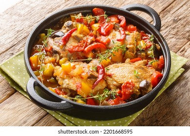 Ivory Coast food Chicken slowly stewed with vegetables and herbs close-up in a frying pan on the table. Horizontal - Shutterstock ID 2201668595