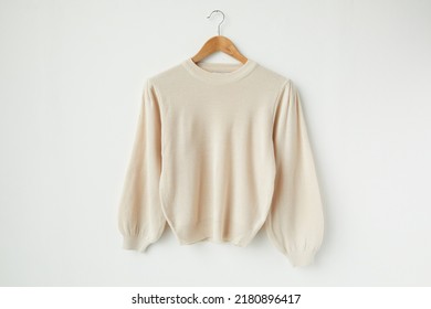 A ivory knitted sweater isolated on a white background