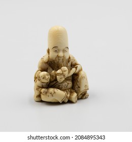 Ivory Netsuke.  A miniature carving or ornamental toggle used to attach a medicine box, pipe, or tobacco pouch to the obi (sash) of a Japanese man's traditional dress.