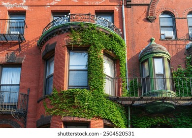 Ivy-Covered Historic Brick Building with Oriel Window and Iron Balcony in Boston, Massachusetts, USA - Powered by Shutterstock