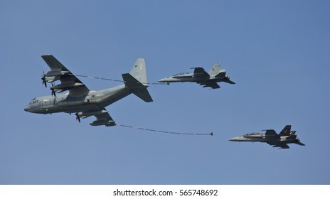 IWAKUNI, JAPAN - MAY 5, 2016: Two U.S. Marines F-18 Hornet fighter jets are refueled in mid-air by a Hercules tanker aircraft at the Japan-U.S. Friendship Day airshow.