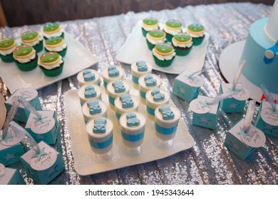 Izmail, Ukraine - May 2020. Festive candy bar for boy birthday party. Blue cupcakes with Teenage Mutant Ninja Turtles, bombonieres. Sweets for family event. 