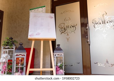 Izmail, Ukraine. May 2020. Guest Seating Plan With Decorative Elements In Festive Wedding Hall. List Of Invited Guests And Table Seats Chart. Elegant Signboard With Information On Reception.