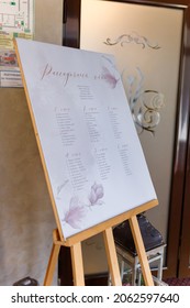 Izmail, Ukraine. May 2020. Guest Seating Plan With Decorative Elements In Festive Wedding Hall. List Of Invited Guests And Table Seats Chart. Elegant Signboard With Information On Reception.