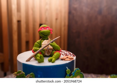 Izmail, Ukraine - May 2020. Top of festive cake for 5 years old boy birthday party with sugar mastic figure Donatello from Teenage Mutant Ninja Turtles cartoon or game.