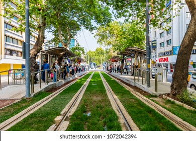 Izmir, Turkey - April 18, 2018 : People are waiting tramway at tramway stop on Gazi Street of Izmir City.