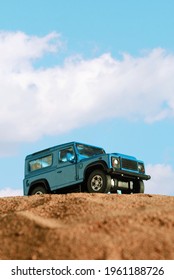 Izmir, Turkey - April 20, 2021: Close up shot of Blue colored 4x4 Suv Car on sand and blue background.