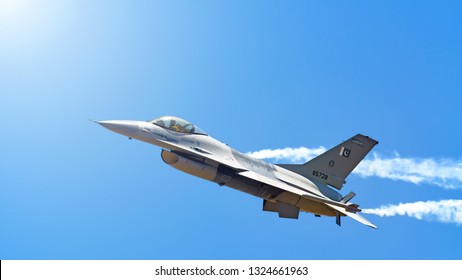 IZMIR, TURKEY - CIRCA MAY, 2011: Pakistan air force Lockheed Martin F-16 fighting falcon military fighter jet airplane flying with smoke against blue sky landscape background panorama banner