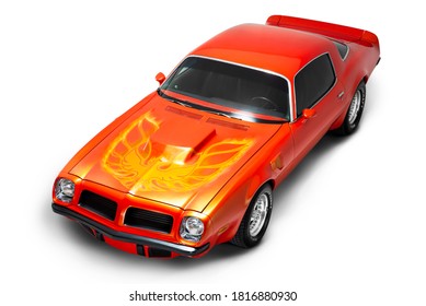 Izmir, Turkey - July 11, 2020: Orange colored Side front and up view of a 1974 Pontiac Trans Am Brand muscle car on a white background studio shot.
