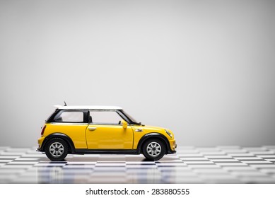 Izmir, Turkey - June 01, 2015.  Mini Cooper S Toy Car On White Background And Checked Floor.