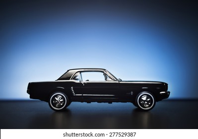 Izmir, Turkey - May 13, 2015.  Ford Mustang 260 Toy Car Product Shot. Side View On A Blue Background. 