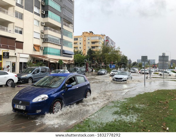 Izmir, Turkey - October 13, 2020: Izmir, Turkey\
Flood in Bayrakli Izmir Turkey. Vehicles have difficulty moving on\
the flooded road.