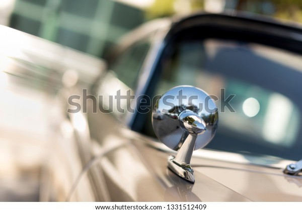 Izmir, Turkey - September\
23, 2018: Driving Mirror of a 1957 Plymouth Vintage car in Izmir\
Turkey.