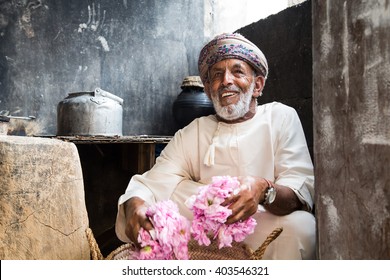 JABAL AL AKHDAR, OMAN - CIRCA APRIL 2016: Omani Man Holding Rose Petals In Front Of The Oven Used For Making Rose Water