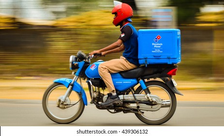 Jabalpur, Madhya Pradesh, India - January 22, 2015 : Panning photograph of a Domino's home delivery bike on its way to deliver food 