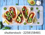 Jack fruit vegan tacos. Top down view table scene over a rustic blue wood background. Healthy eating, plant-based pulled pork meat substitute.