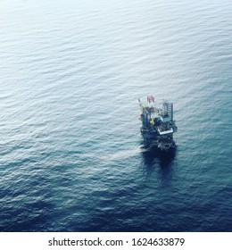 Jack up rig for oil and gas operations in the gulf of Thailand. Offshore jack up crane tower tender rig or barge or Derrick of Tender Assisted Drilling Oil Rig (Barge Oil Rig) on The Production.