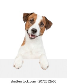 jack russell terrier puppy looks above empty white banner. isolated on white background - Shutterstock ID 2072832668