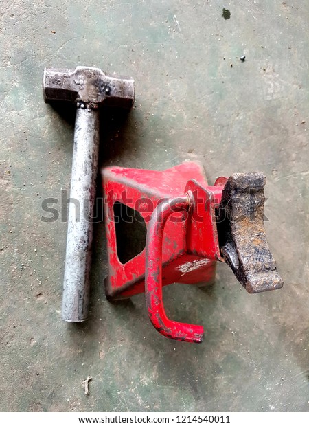 Jack stand and hammer on Cement floor\
background, Use for lift cars and\
motorcycle.\
\
