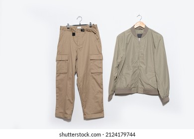 Jacket With Khaki Pants On Hanger On The Gray Background