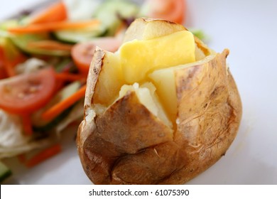 Jacket Potato Served Hot With Butter And A Side Salad