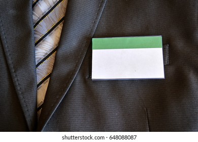 Jacket And Striped Tie With A Blank Name Badge Close Up