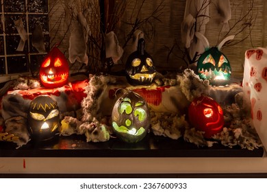 Jack-o'-lanterns of different colors and shapes on Halloween holiday - Shutterstock ID 2367600933