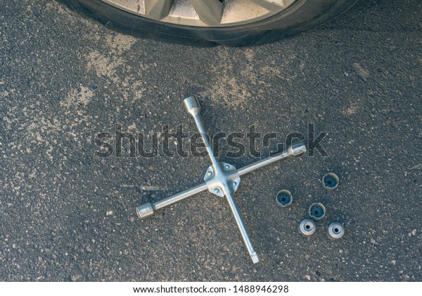 jack-screw, cross wrench and bolts for\
changing of punctured wheel. Hole in the tire.\
Concept