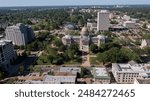 Jackson, Mississippi, USA - April 23, 2024: Afternoon light shines on the historic Capitol and buildings of downtown Jackson skyline.