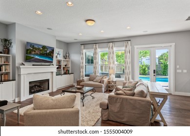 Jacksonville Beach, Florida / USA - November 9 2019: Living Room With White Fireplace And Pool View