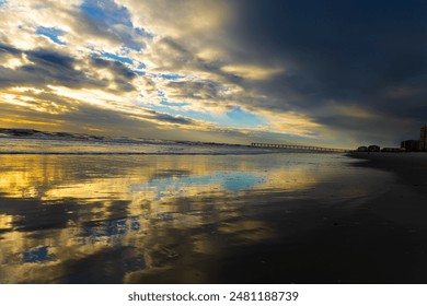 Jacksonville Beach sunrise: Golden rays streak over the Atlantic, painting the sky in pastel hues as waves whisper against the shore, welcoming a new day. - Powered by Shutterstock