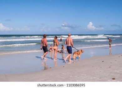 Jacksonville Beach,Florida,USA.05.31.2015.
Family Enjoying And Walking With Dog The Beautiful Jacksonville Beach, Seascape,sun,clouds,wave,white Sand, Horizon Over The Atlantic Ocean.
