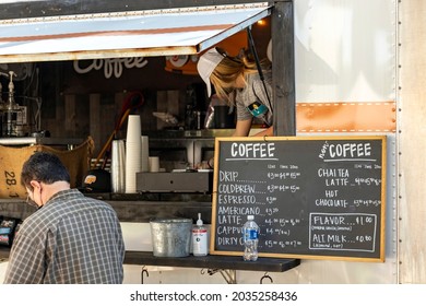 Jacksonville, Florida United States -  Saturday May 1, 2021: A Man Buys Coffee From A Trailer Parked At The River Side Arts Market Under The Fuller Warren Bridge