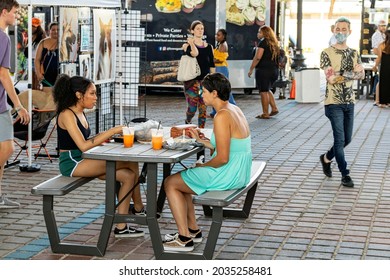 Jacksonville, Florida United States -  Saturday May 1, 2021: Two Females Share A Meal At A Table Under The Fuller Warren Bridge During The Arts Market Event 