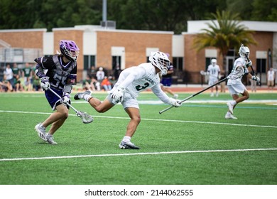 Jacksonville, Florida USA. April 2nd 2022. High Point University Men's Lacrosse Attacker Brayden Mayea And Jacksonville's Defender Jordan Young In Action.