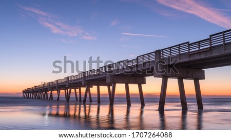 Jacksonville, Florida, USA beach view with Jacksonville Pier at dawn.