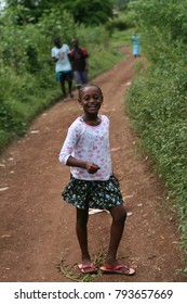 JACMEL, HAITI - June 2013: Young girl shows sass in a side walking path