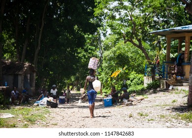 Jacmel / Haiti - May 29 2015: Local Outdoor Market Woman Carrying Basket on head