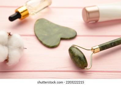 Jade Facial Roller On Pink Background With Copy Space. Top View