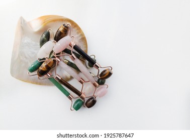 Jade, Tiger Eye, Quartz Rollers Close Up. Different Color Rollers For Face Massage. Top View, Space For Text. Concept Of Beauty Care For Face. Frame, Blank, Template