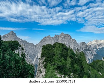 Jagged rock formation with scenic view of rugged mountain peak Prisank in majestic Julian Alps seen from Triglav National Park, Vrsic pass, Slovenia. Wanderlust wild Slovenian Alps. Sharp steep ridges - Powered by Shutterstock