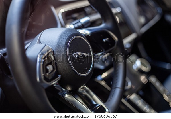 Jaguar car interior.\
Fragments steering wheel with multimedia control buttons  and logo\
Jaguar close-up with blur, soft and selective focus. Moscow, Russia\
- June 2020. 