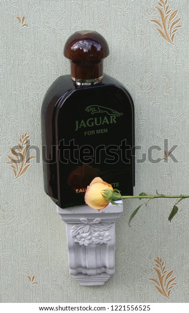 Jaguar for Men, Eau de Toilette, large perfume\
bottle on an antique wall console with ornament decorated with a\
rose\
Kassel, Germany, 10.03.2018: Jaguar for Men is a men\'s\
fragrance, launched in\
1988