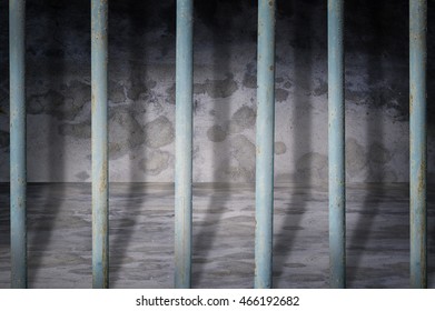 Jail cells iron bars casting shadows on the prison floor 