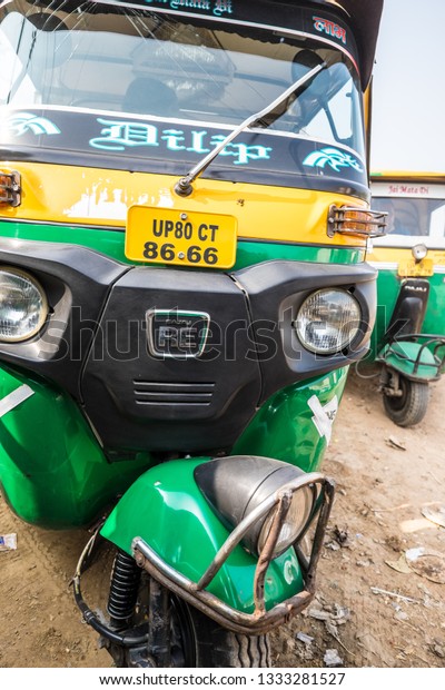 Jaipur, India -\
December 25, 2018, Auto rickshaw taxis on a road in India. These\
iconic taxis have recently been fitted with CNG powered engines in\
an effort to reduce\
pollution.