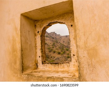 JAIPUR, INDIA - Feb 28, 2020: A View Through A Portal Towards The Mountain Top Fortifications Above Jaipur, Rajasthan, India