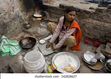 JAIPUR, INDIA - MARCH 02: Unidentified Indian Poor Girl Cooking Chapatti On March 02, 2013 In Jaipur, India.chapati - A Traditional Indian Flatbread