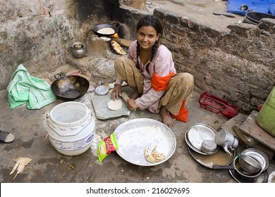 JAIPUR, INDIA - MARCH 02: Unidentified Indian Poor Girl Cooking Chapatti On March 02, 2013 In Jaipur, India. Chapati - A Traditional Indian Flatbread