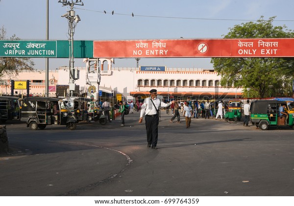 JAIPUR, INDIA - MAY\
10:Traffic police controlling the vehicles on the road. Passengers\
and commuters outside Jaipur Railway station on May 10, 2017\
Rajasthan, North India.\
